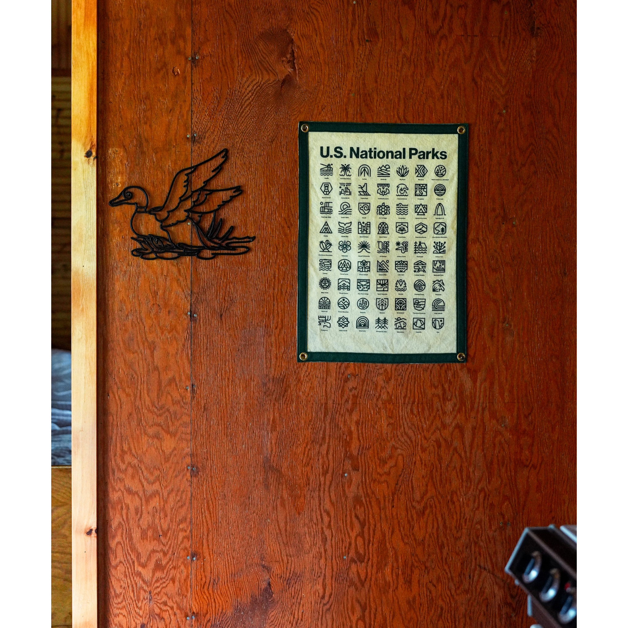 Forager Provisions LTD Oxford Pennant National Parks wool felt camp flag with Steve Wolf graphic hanging on wood wall