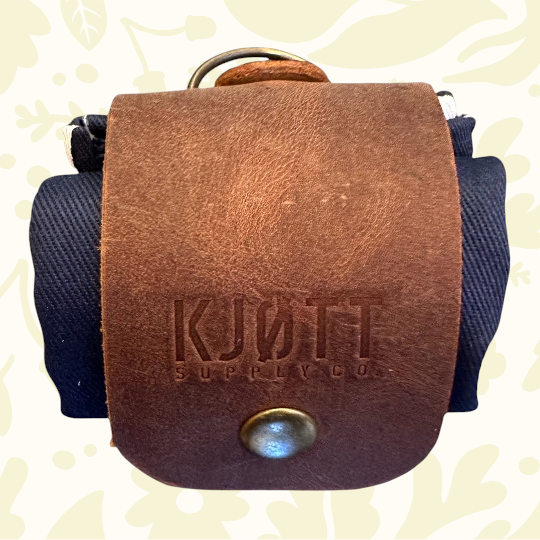 Forager Provisions X Kjøtt bag with brass snap, fabric strap—compact, rugged foraging gear, perfect outdoor supply bag.