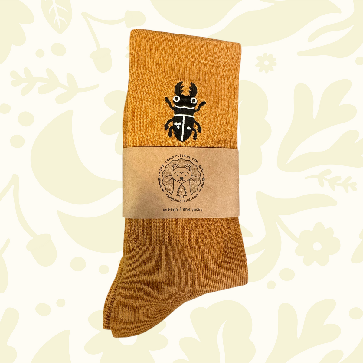 Camp Mustelid orange cotton socks with beetle, grub, and floral design, fox label—perfect insect lover gift.