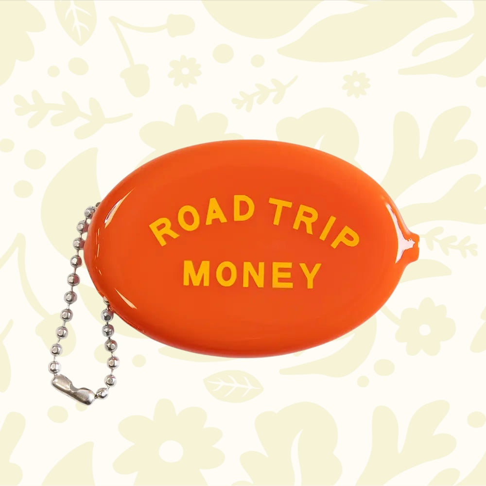 Three Potato Four orange coin pouch with yellow "ROAD TRIP MONEY" text and metal beaded keychain, travel wallet accessory.