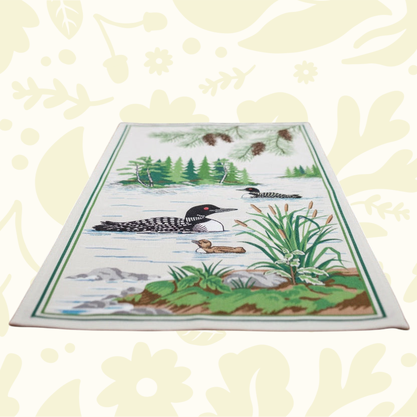 Forager Provisions LTD PAINE’S cotton kitchen towel featuring a rustic loon lake scene with pine trees and cattails.
