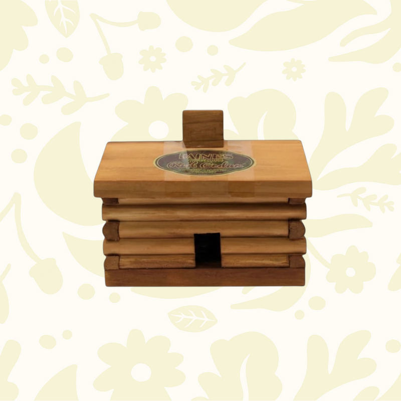 PAINES Red Cedar Incense Cones, 10 count in log cabin box, on floral background. Premium fragrant incense by Paines.