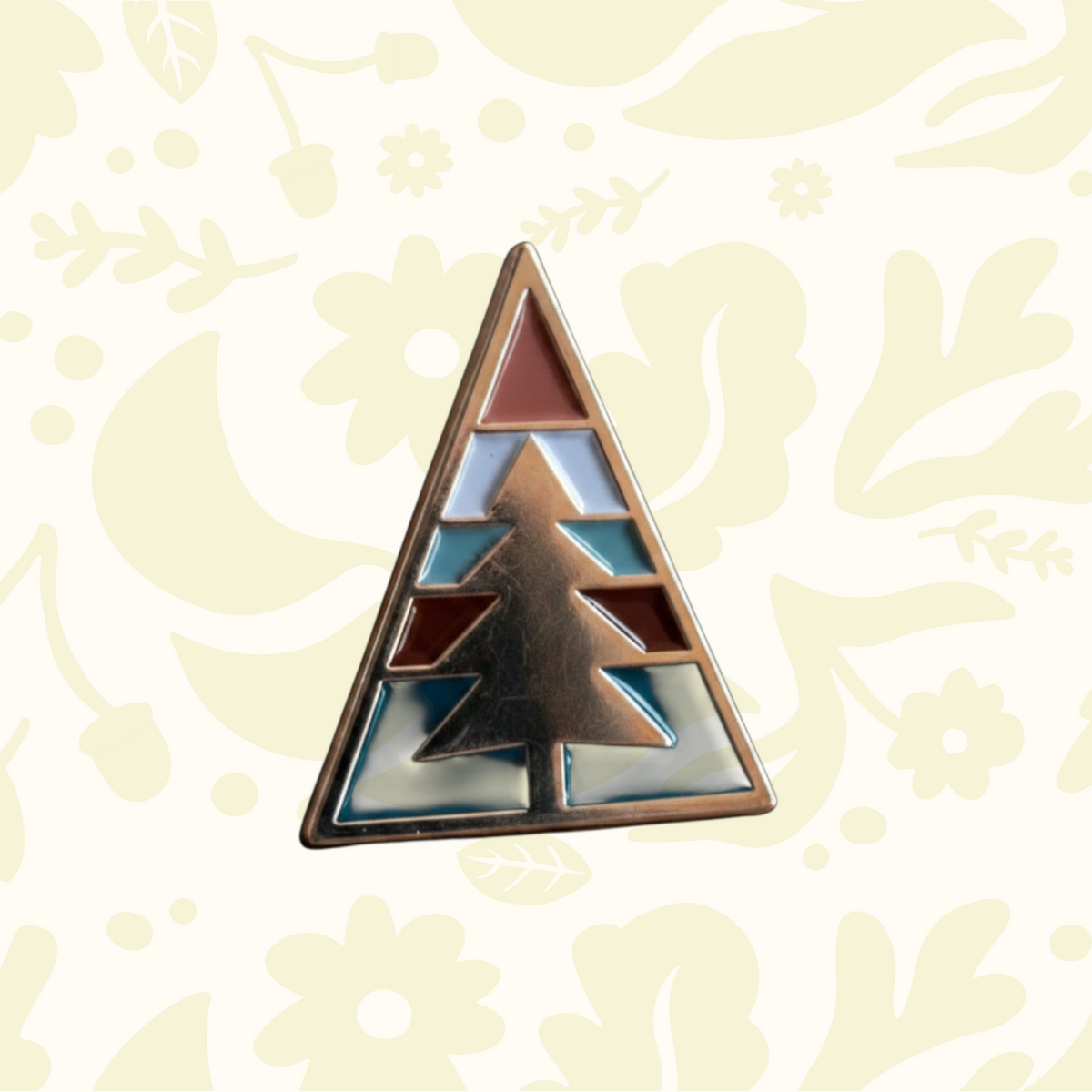 Forager Provisions LTD Ponderosa Pin featuring a triangular design with a stylized pine tree in enamel and metal.