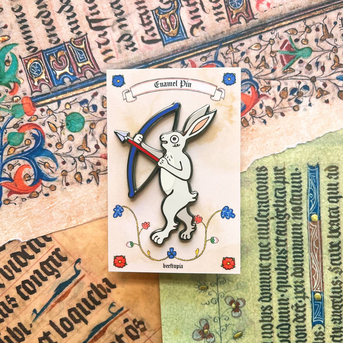 Forager Provisions LTD Beeftopia enamel pin featuring a white rabbit archer on a medieval-style backing card.