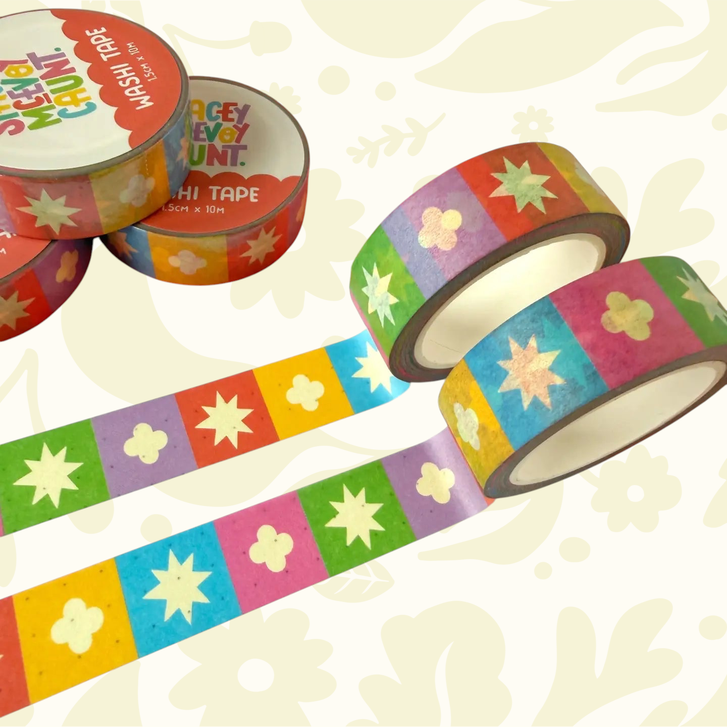 Four Rainbow Medieval Grid Tile Pattern Washi Tapes by Stacey McEvoy Caunt unspooled on a colorful patterned surface.