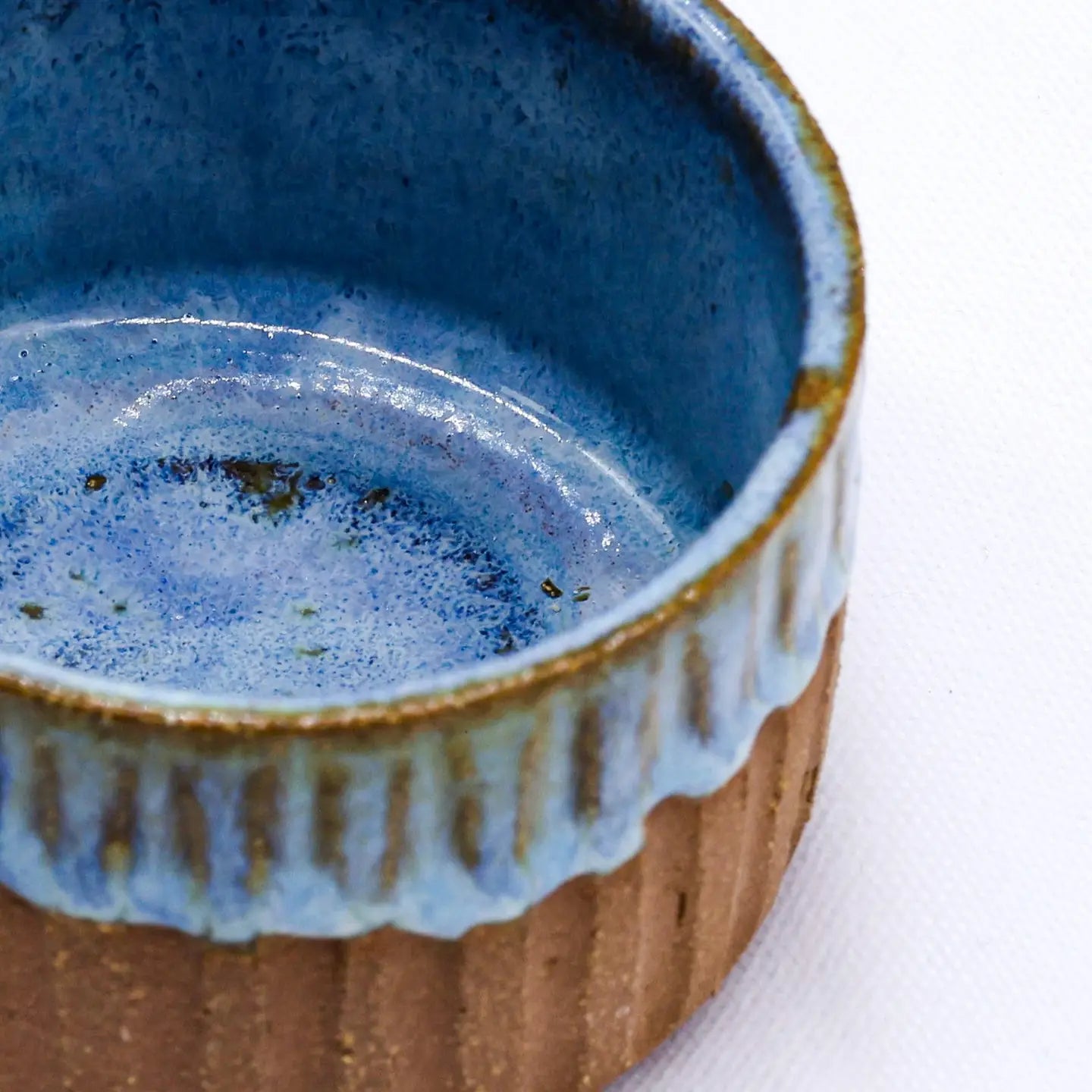 Forager Provisions LTD Ribera Bluvio Arte handmade stoneware mug with a textured brown base and blue glazed interior.