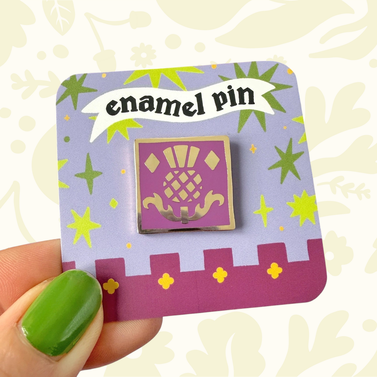 Forager Provisions LTD Stacey McEvoy Caunt Scottish thistle enamel pin with gold-tone detailing on a purple backing card