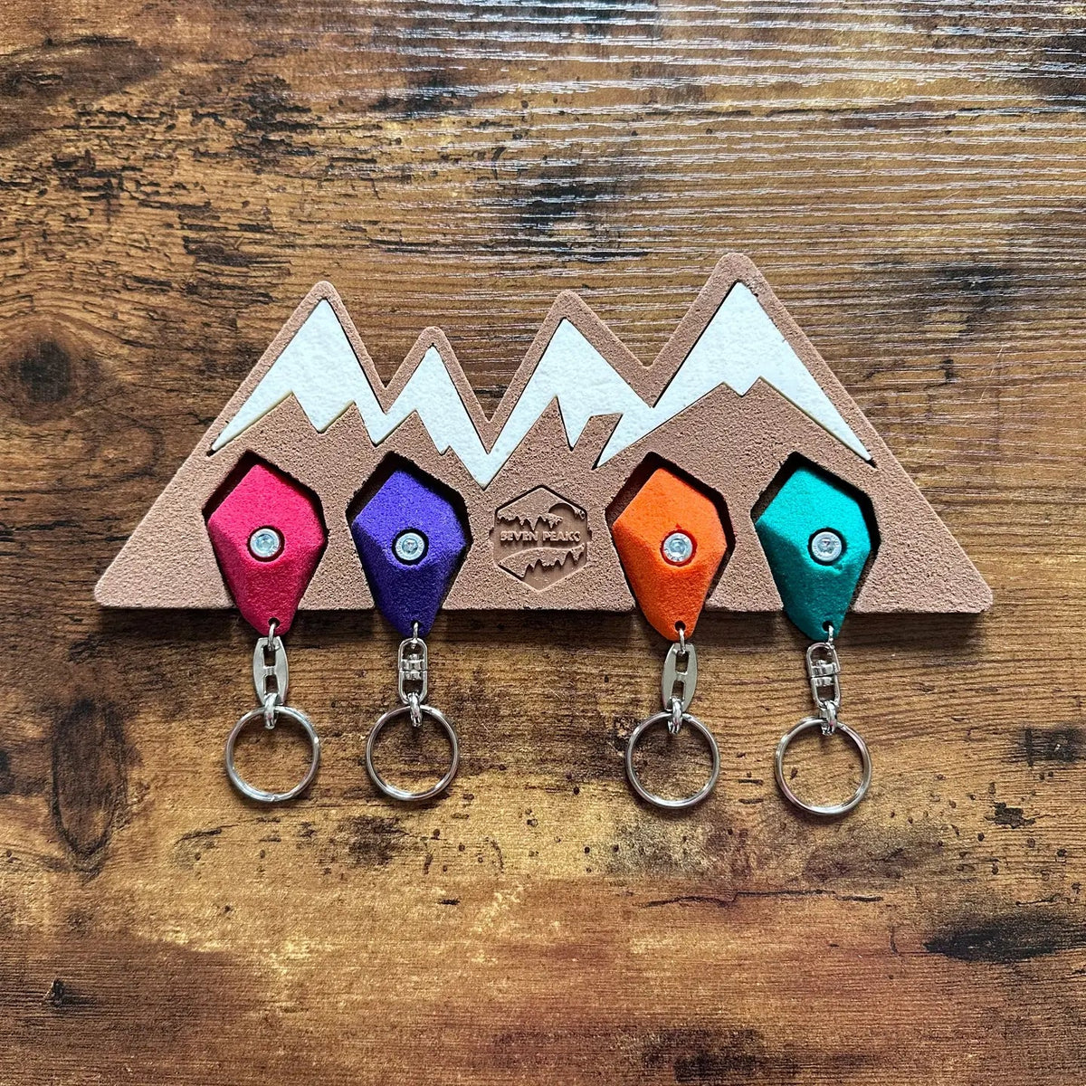Forager Provisions LTD Seven Peaks mountain-shaped key holder with four colorful rock climbing hold keychains