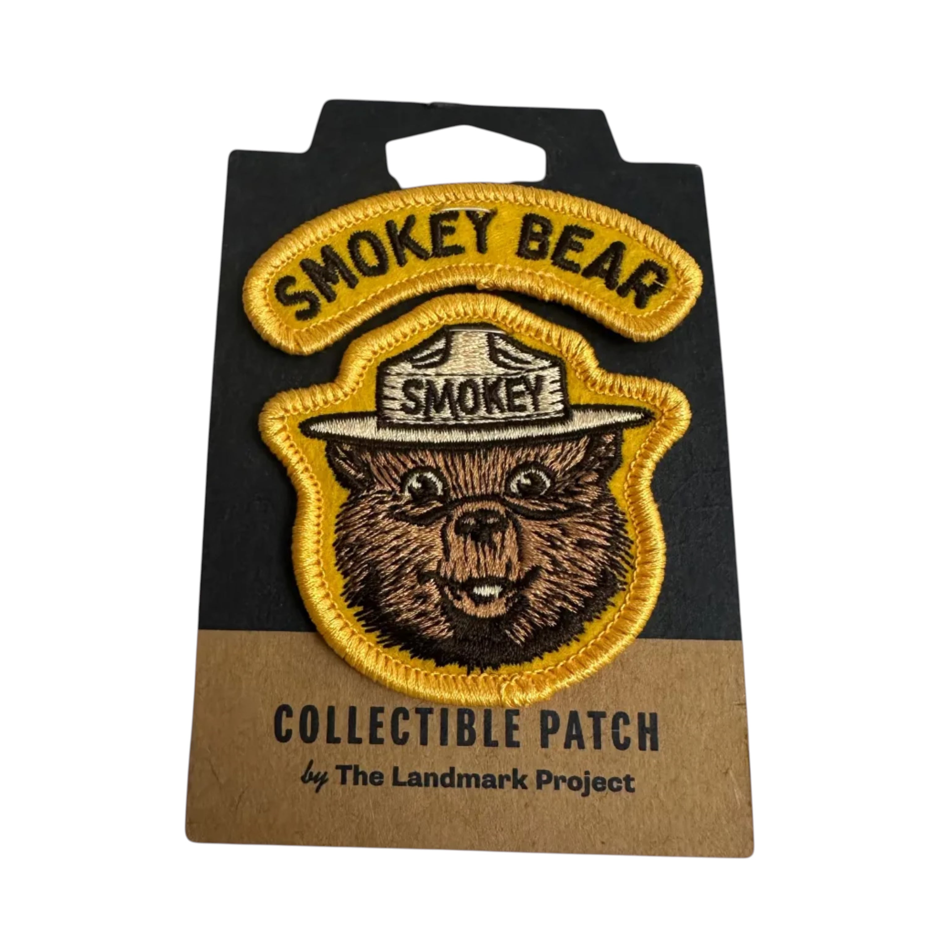 Forager Provisions LTD embroidered Smokey Bear varsity patch with yellow border on branded backing card.