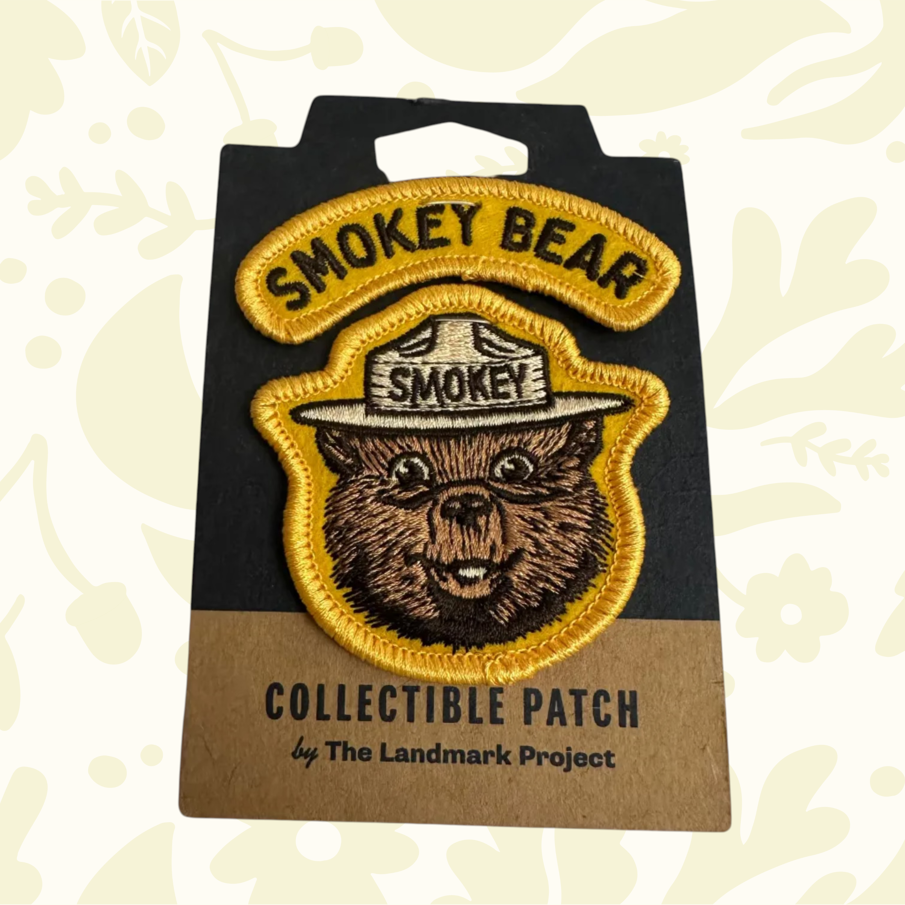 Forager Provisions LTD embroidered Smokey Bear varsity patch with yellow border on branded backing card.