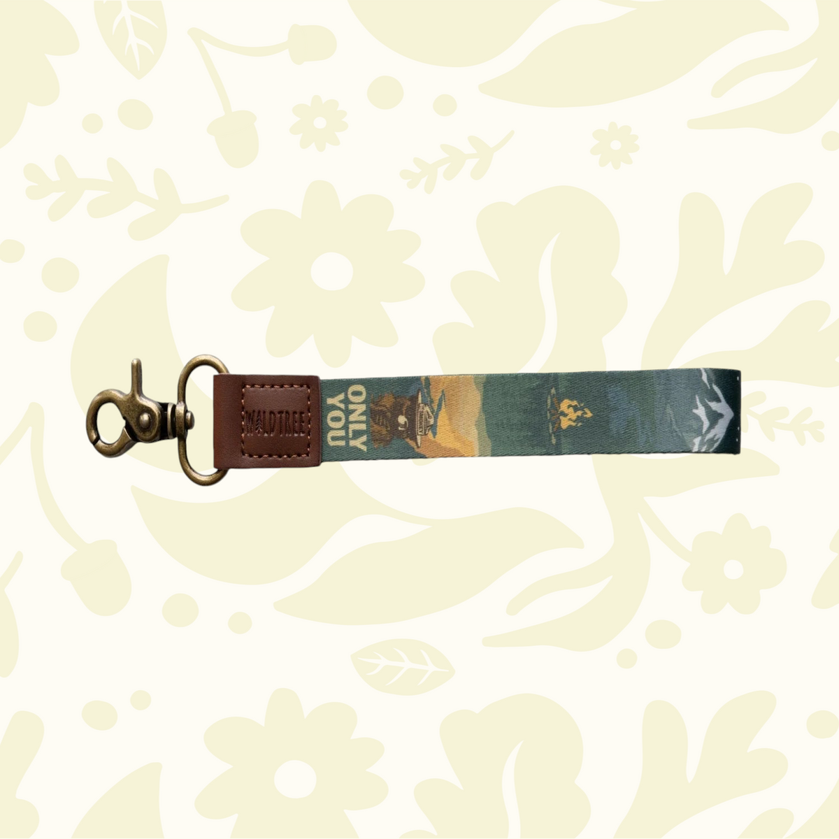 Wildtree Smokey Bear keychain—leather/fabric, clasp, camera charm, forest scene, floral pattern. Outdoor adventure gift.