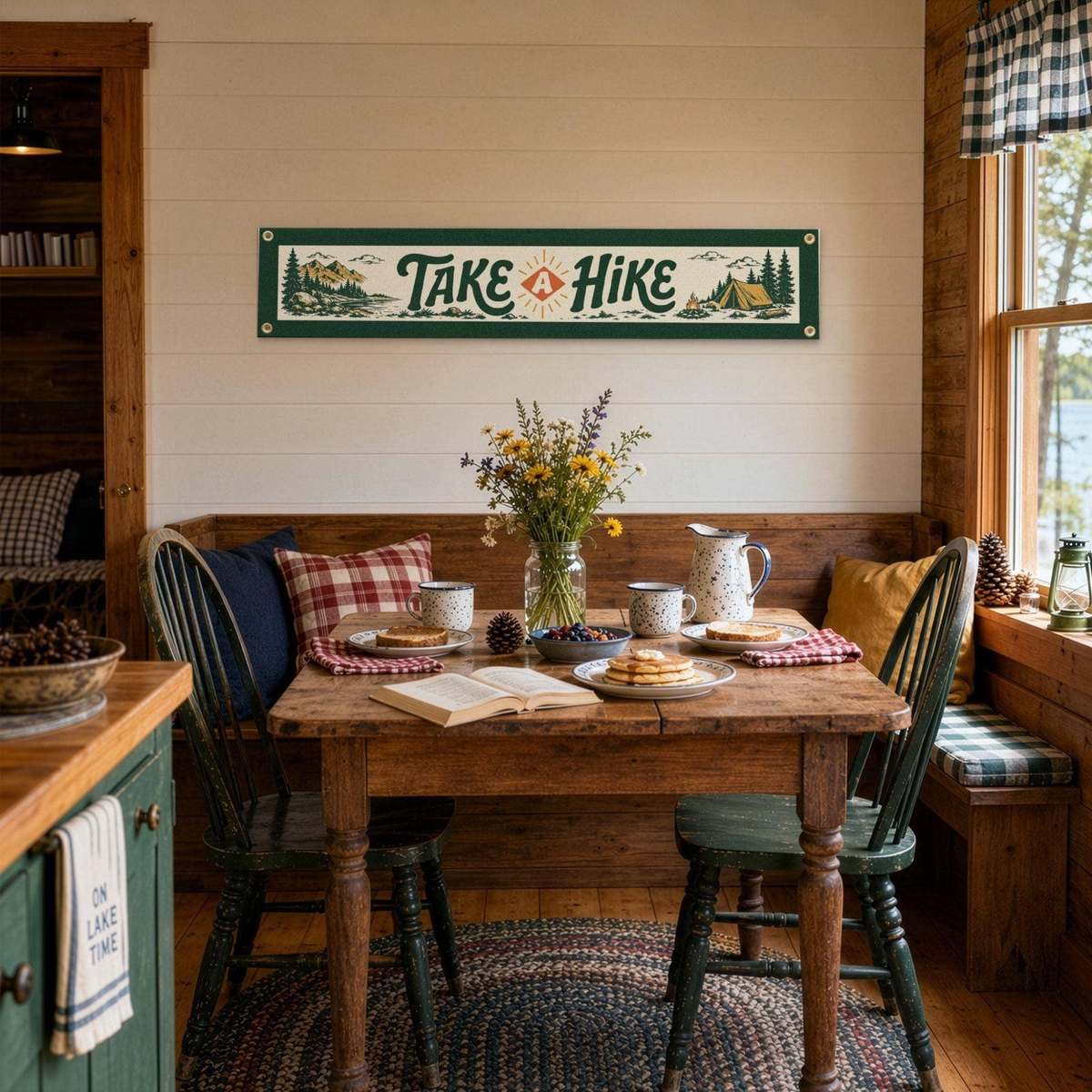 Forager Provisions LTD Benoit's Design Co. Take A Hike felt banner hanging in a rustic cabin dining area.