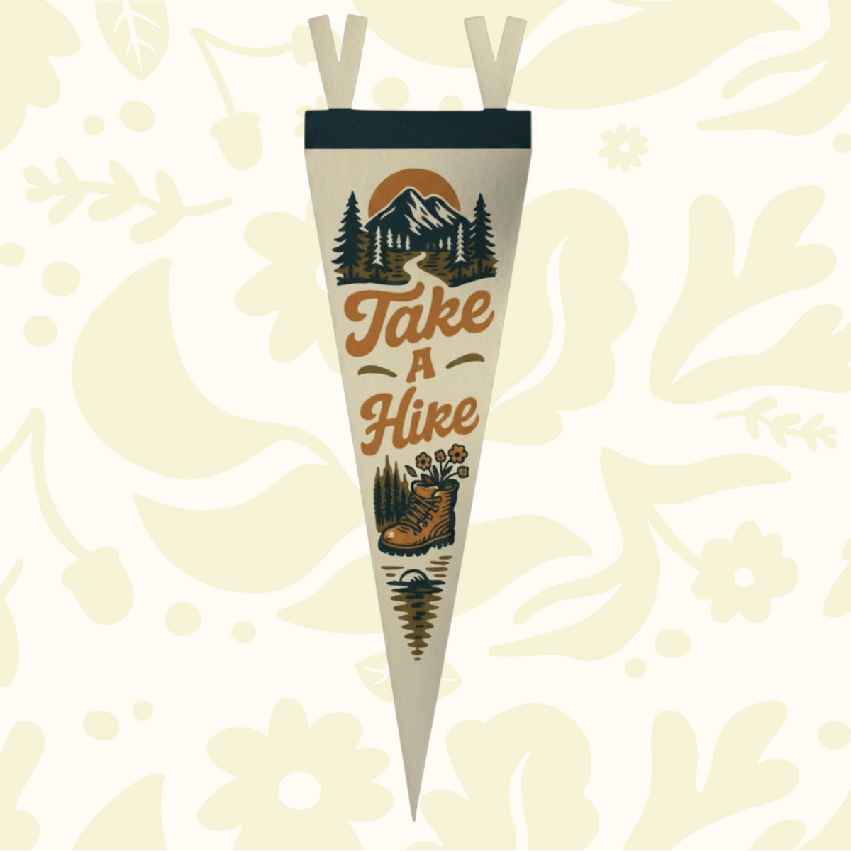 Forager Provisions LTD Take A Hike felt pennant featuring vintage mountain and hiking boot graphics on a wooden desk.