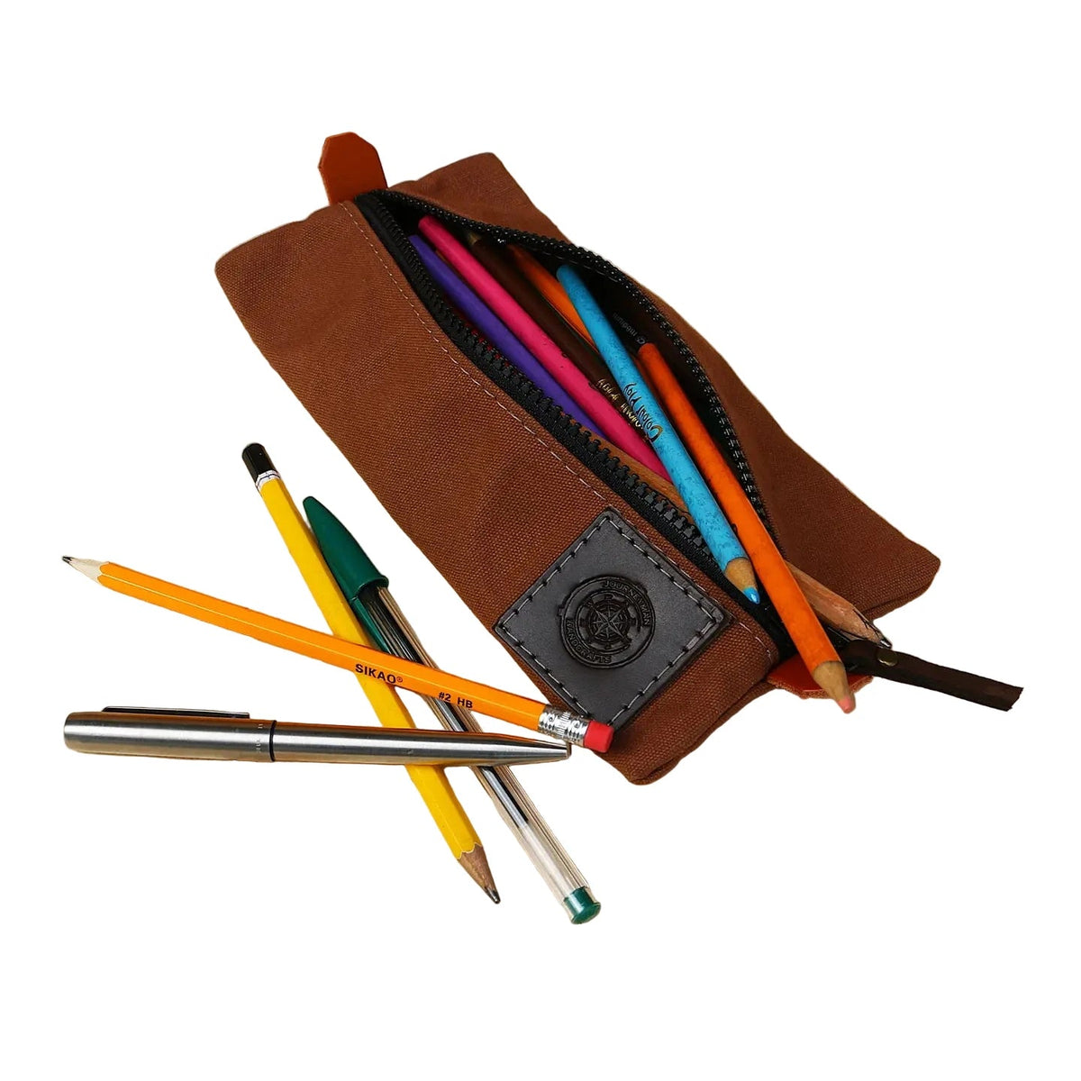Forager Provisions LTD Journeyman Craft tan canvas pencil case with a zip closure and assorted pens and pencils.
