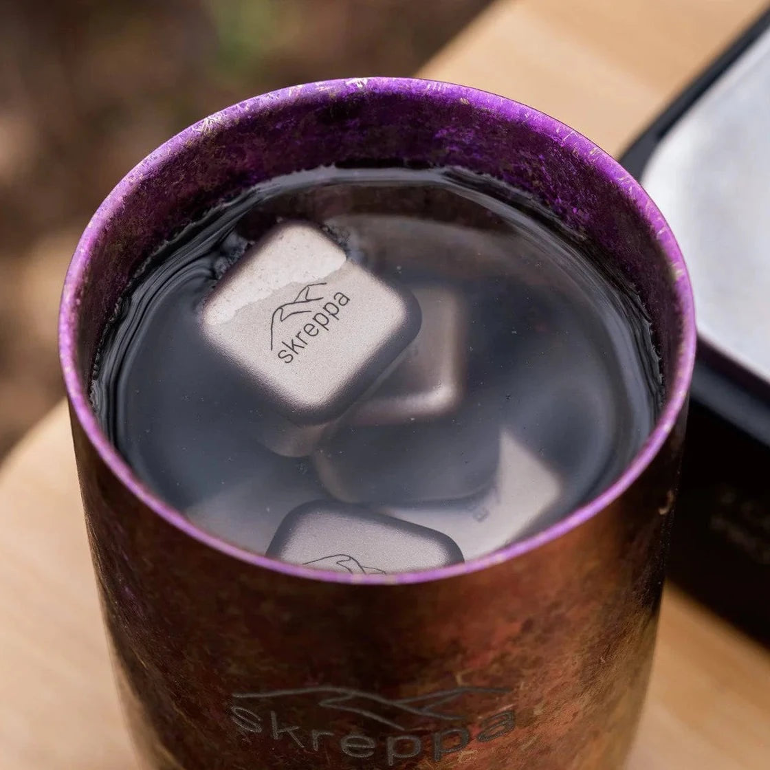 Forager Provisions LTD Skreppa titanium ice cubes cooling a drink in a metallic purple tumbler