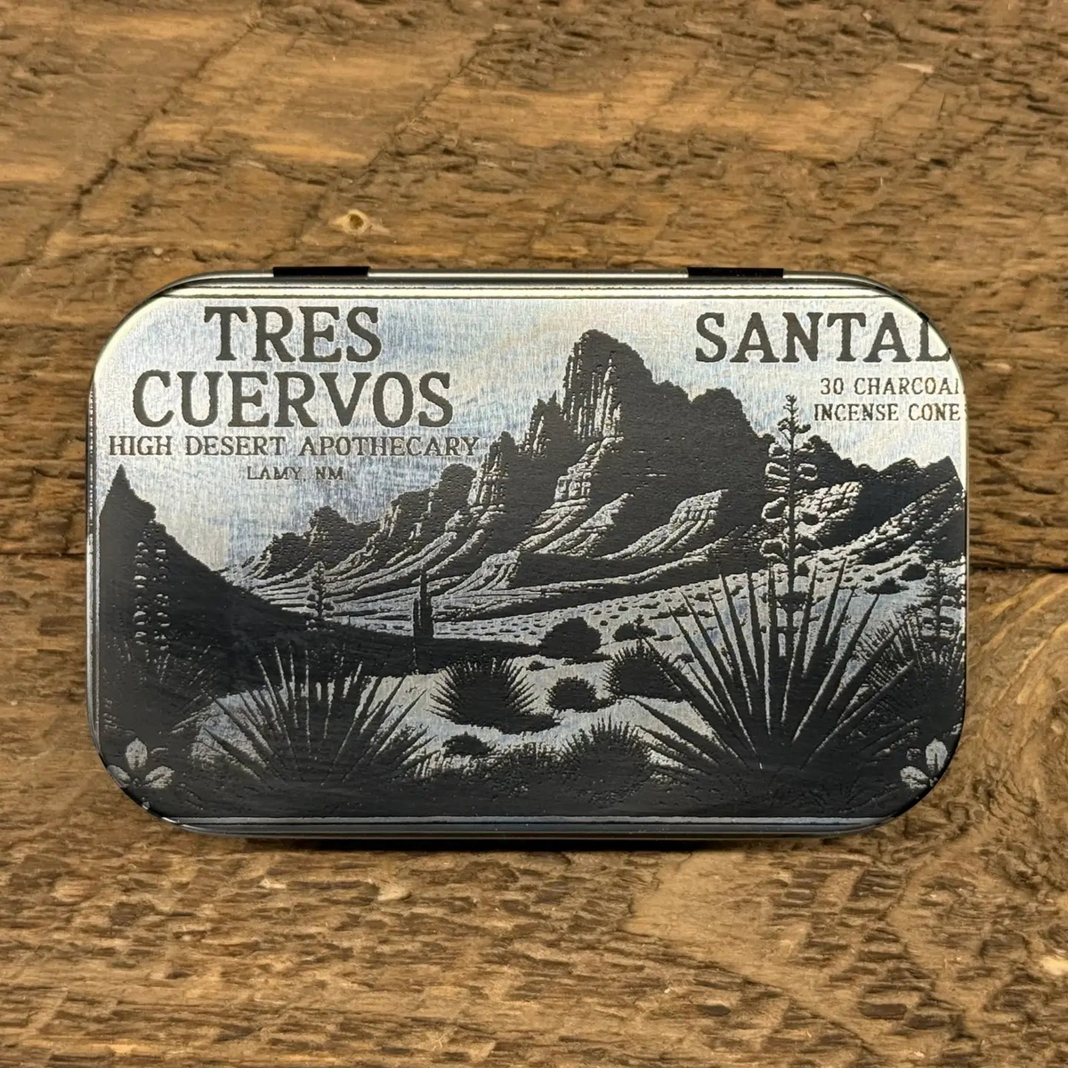 Forager Provisions LTD Tres Cuervos Santal charcoal incense cones in a metal tin with desert landscape illustration.