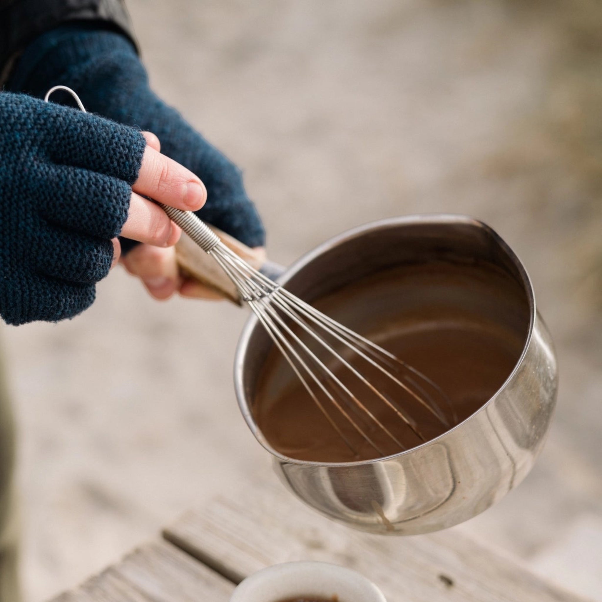 Forager Provisions LTD Harth vegan hot chocolate being whisked in a metal pot and poured into a rustic ceramic mug