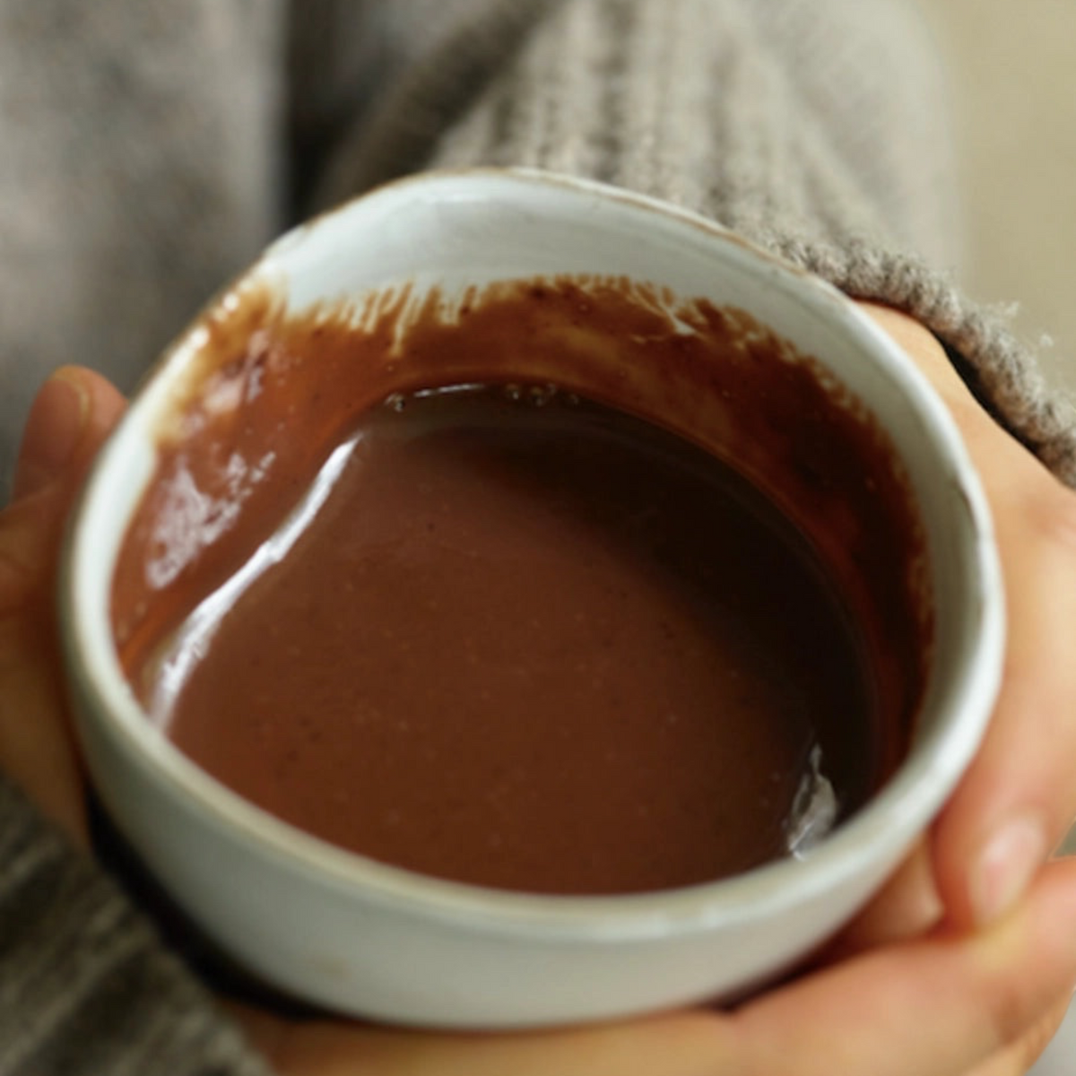 Forager Provisions LTD Harth Winter Solstice vegan spiced hot chocolate in a ceramic mug held by hands in a sweater