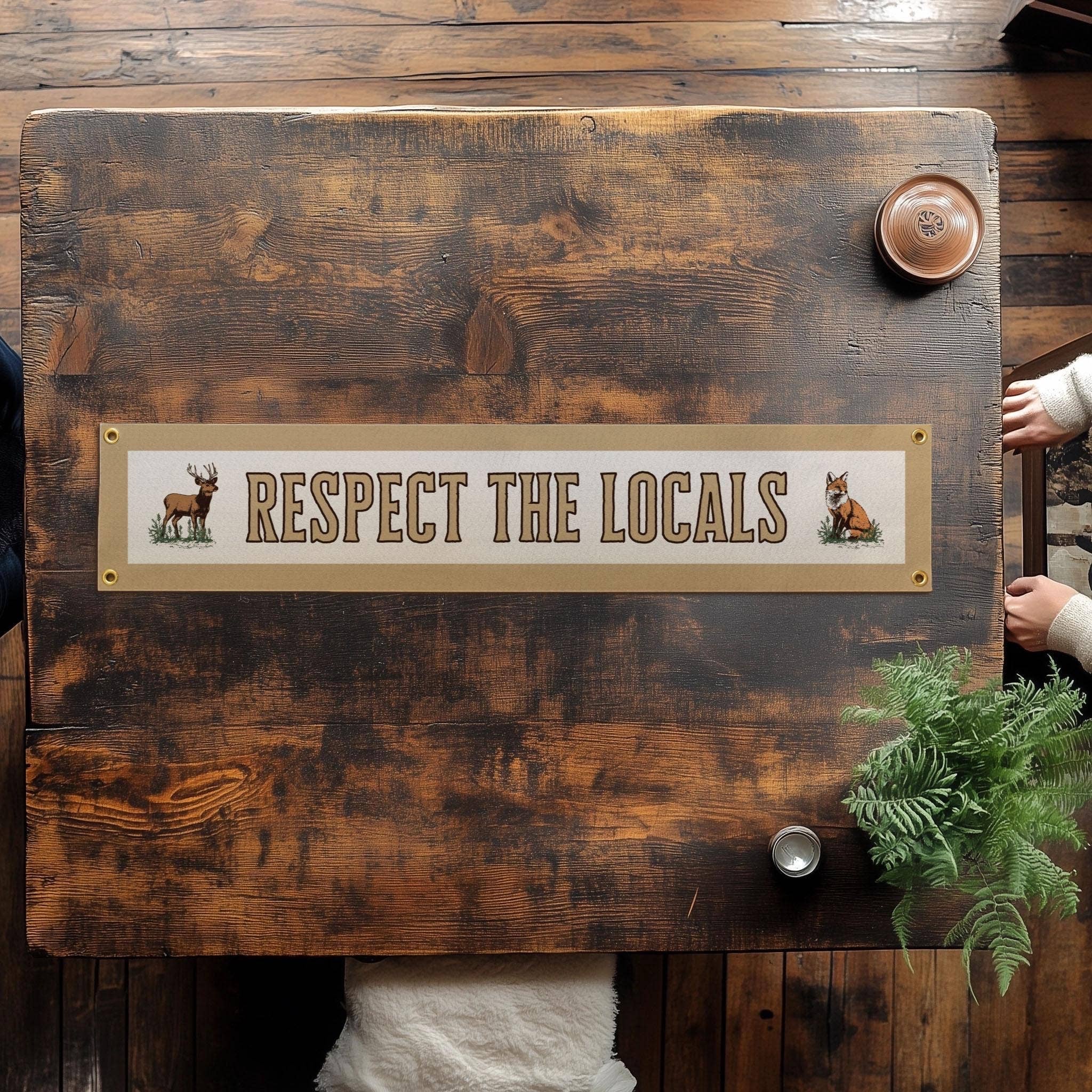 Forager Provisions LTD vintage felt banner with Respect The Locals text, deer and fox illustrations, and brass grommets