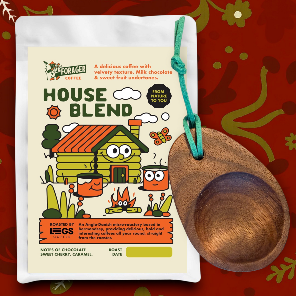 Forager Provisions LTD walnut wood camping scoop with a green tie, presented in a gift tin on a textured surface.