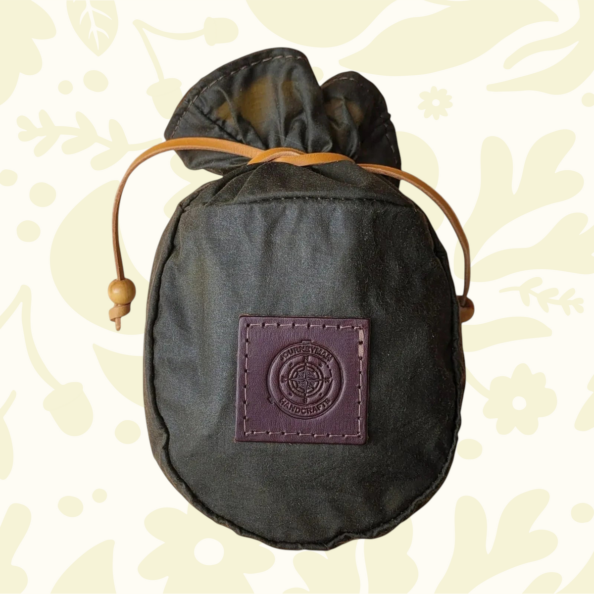 Forager Provisions LTD Journeyman Handcraft forest green waxed canvas coffee pouch with a leather tie closure.
