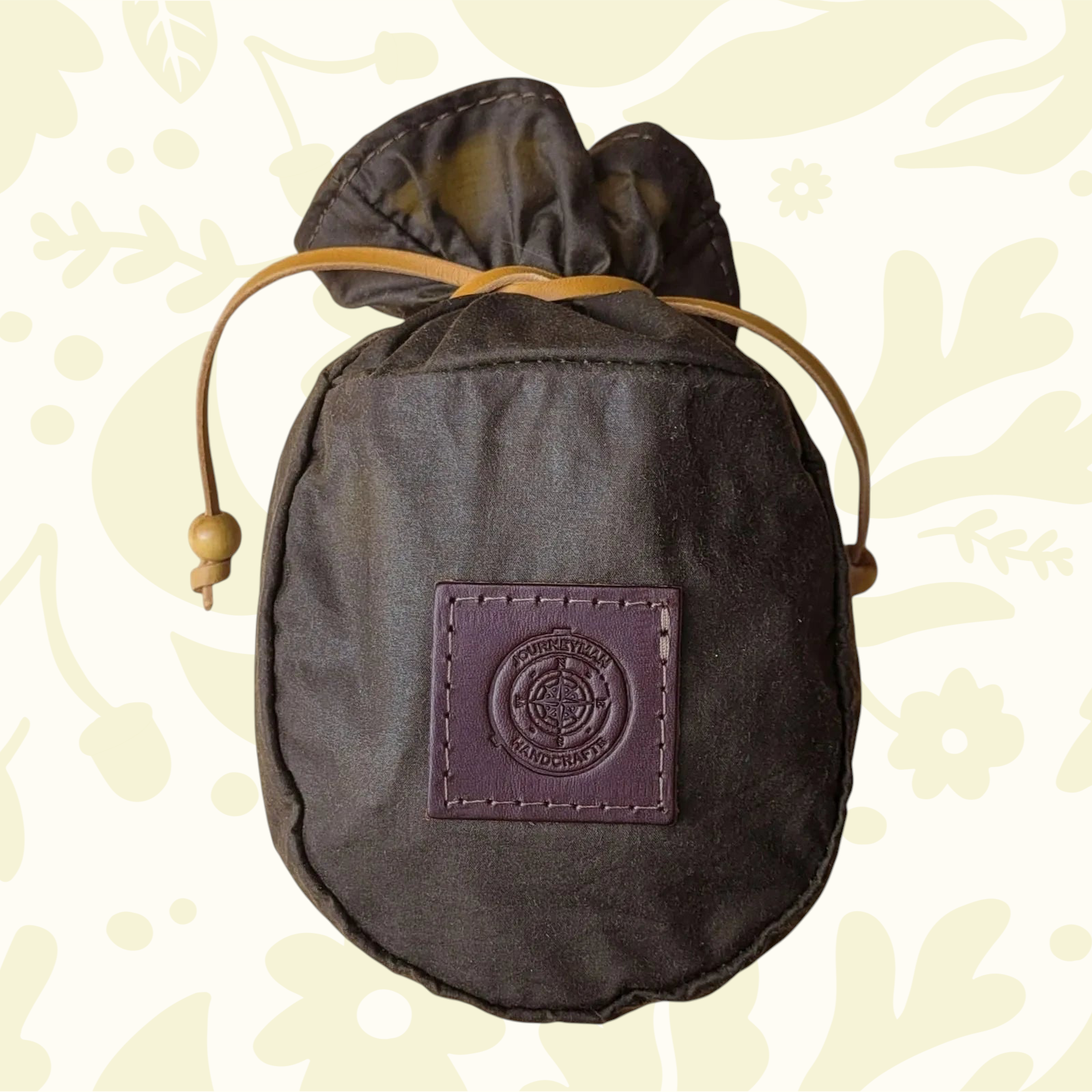 Forager Provisions LTD Journeyman Handcraft coffee brown waxed canvas pouch with a drawstring closure and leather patch.