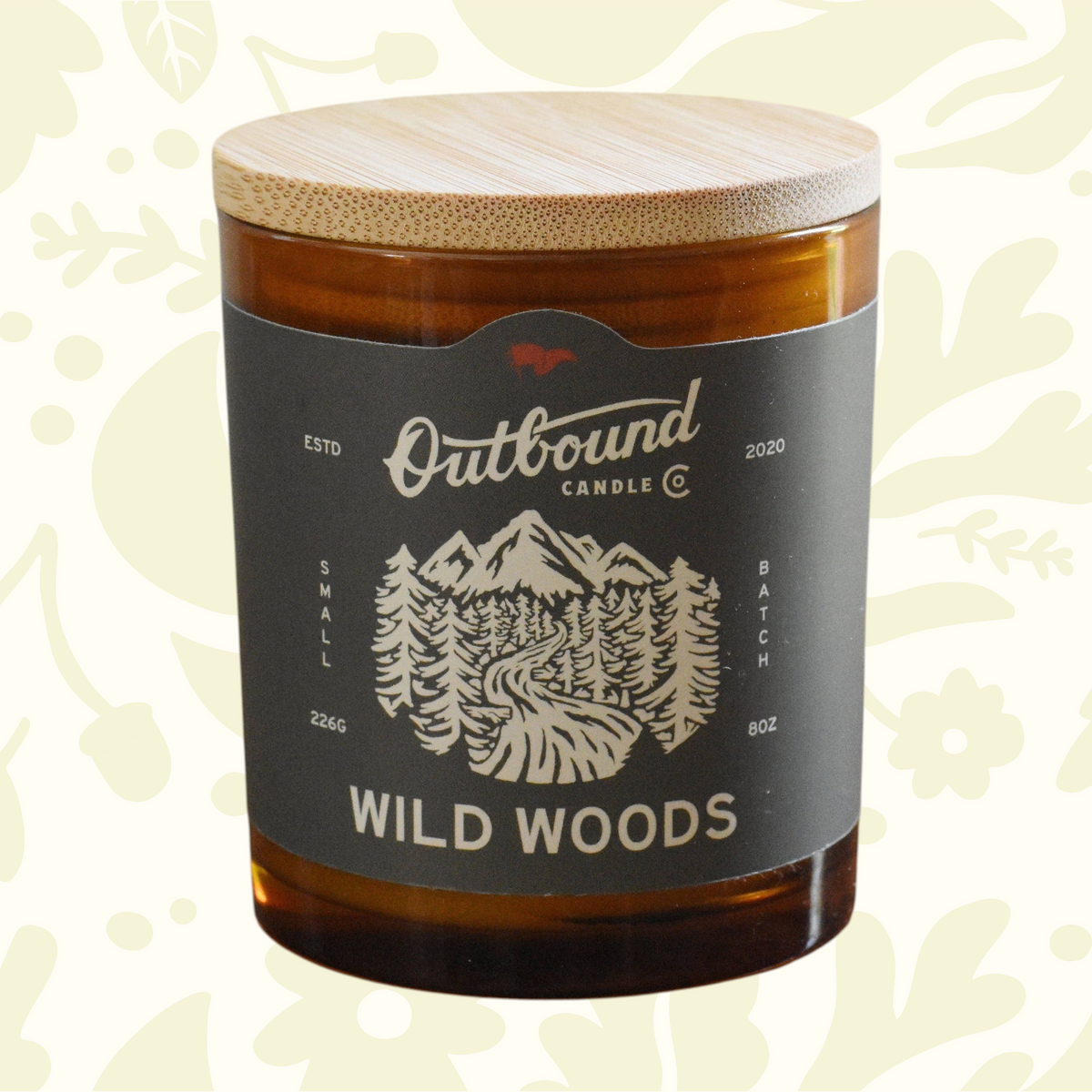 Forager Provisions LTD Outbound Candle Co Wild Woods soy candle in an amber glass jar with a bamboo lid.