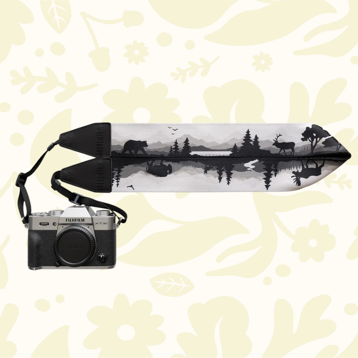 Forager Provisions LTD Wildtree camera strap featuring a black and white forest wildlife print attached to a camera.