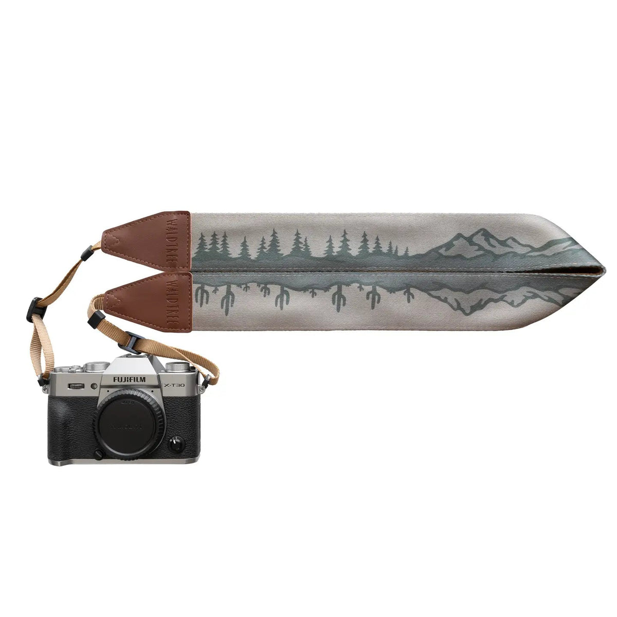 Fujifilm camera with Wildtree Landscape Camera Strap featuring cacti, trees, mountains, and brown leather ends for style.