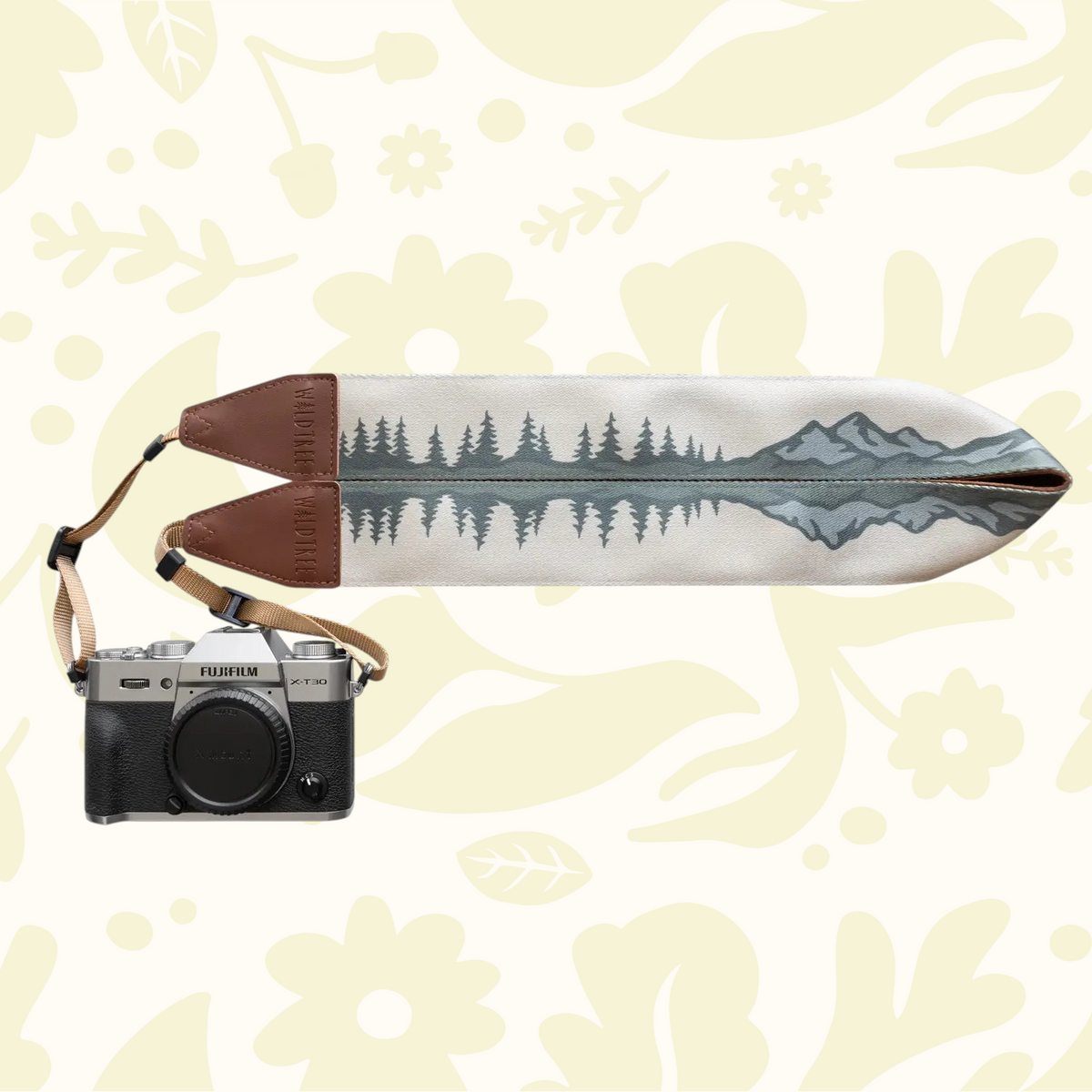 Forager Provisions LTD Wildtree camera strap featuring a forest and mountain landscape print on a mirrorless camera