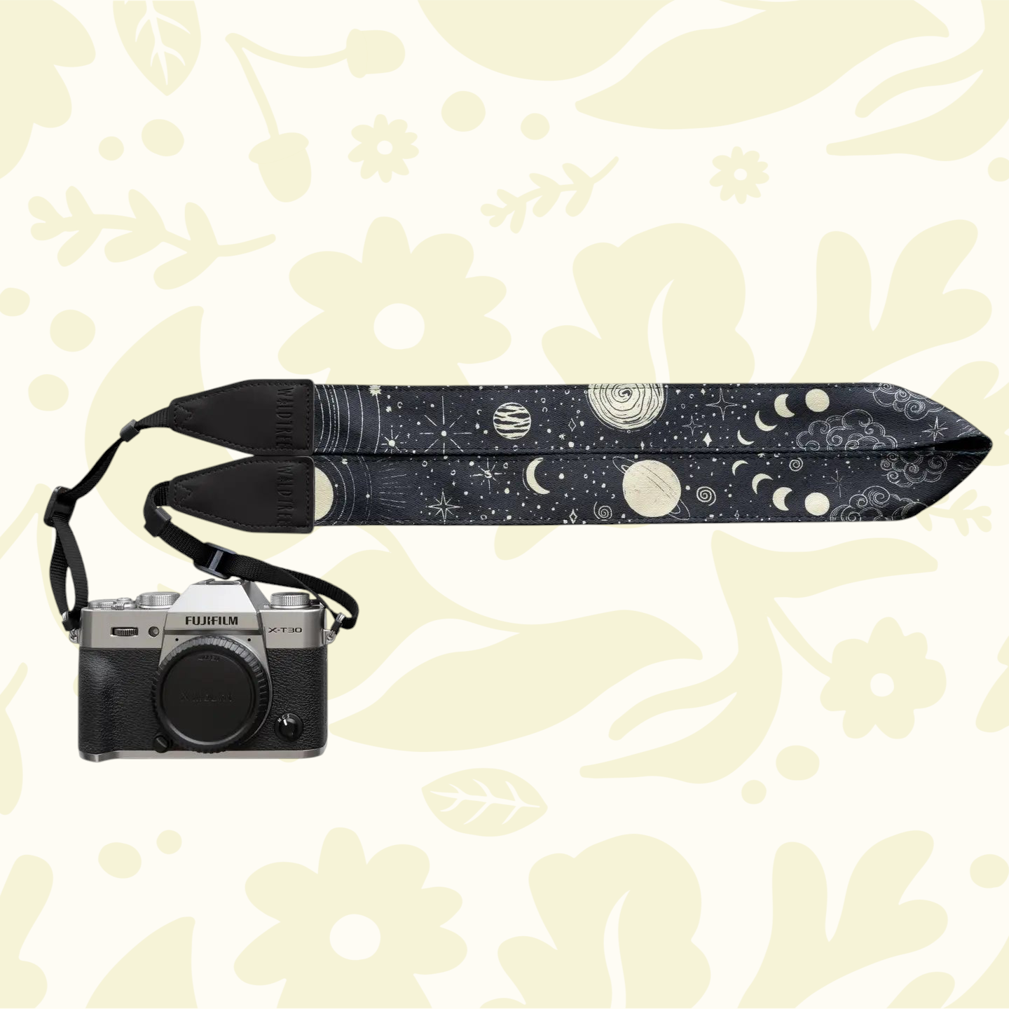 Forager Provisions LTD Wildtree camera strap with celestial sun and moon pattern attached to a silver mirrorless camera