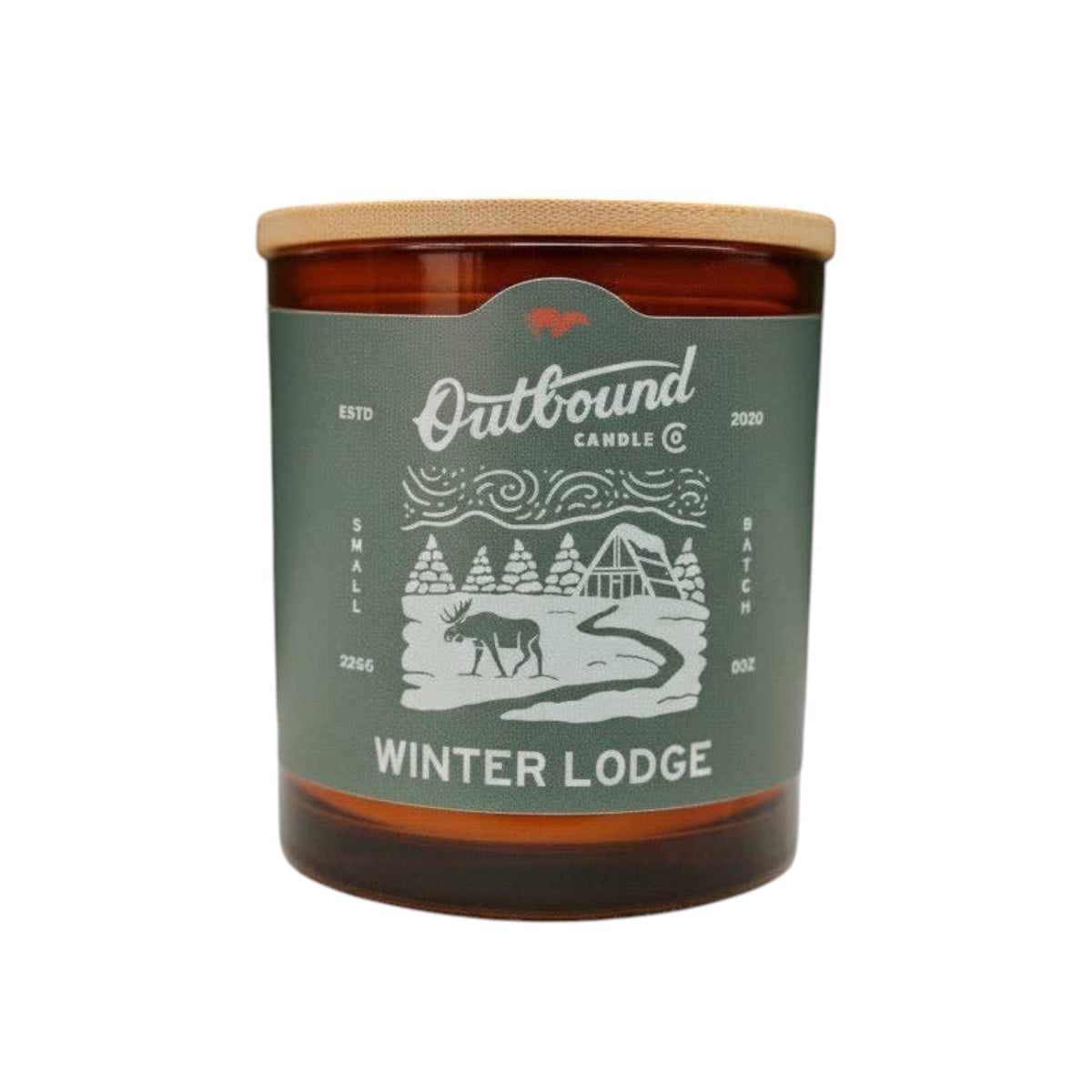 Forager Provisions LTD Winter Lodge soy candle in an amber glass jar with a bamboo lid and pine forest label.