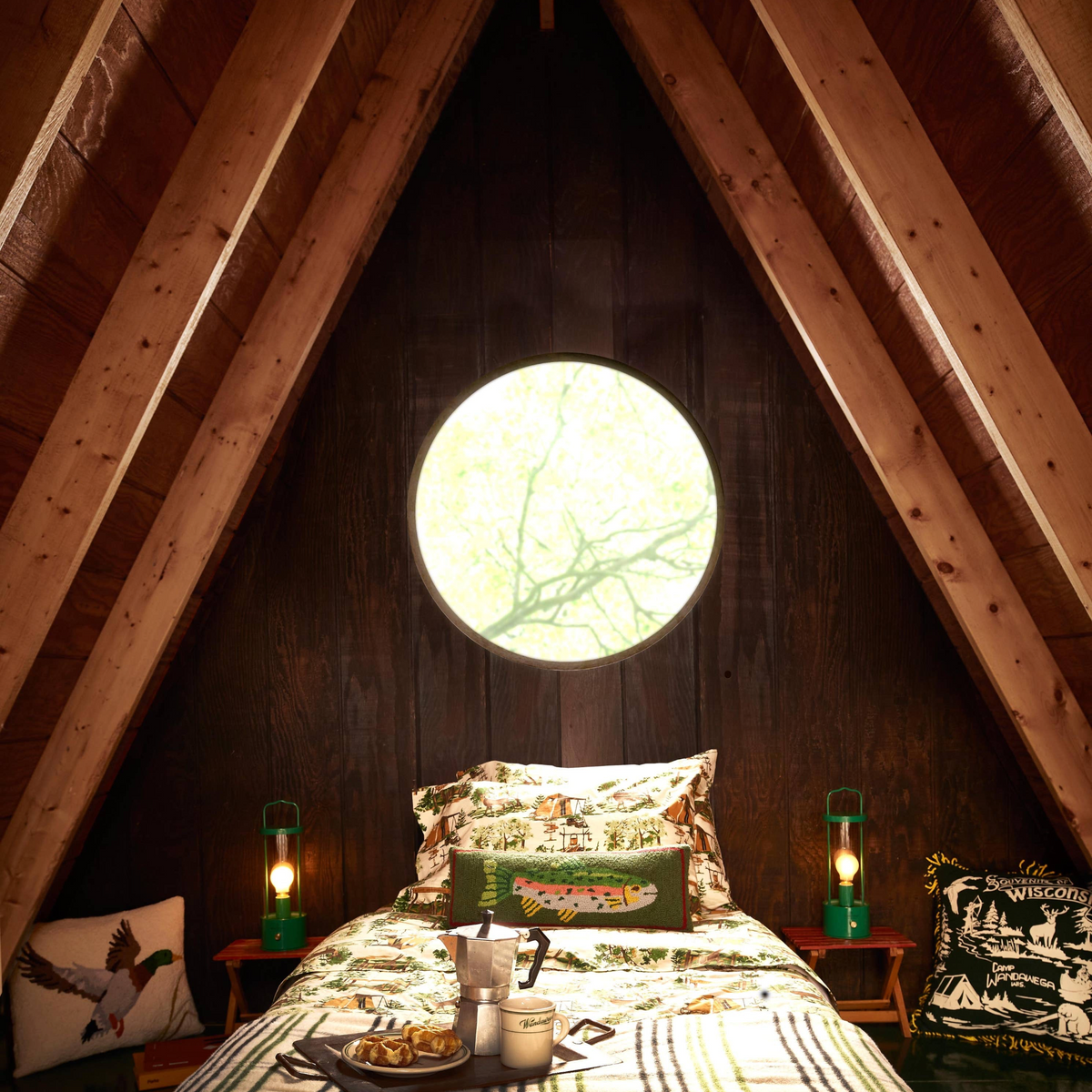 Forager Provisions LTD Peking Handicraft x Camp Wandawega cotton sheet set with woodland print in a rustic A-frame cabin