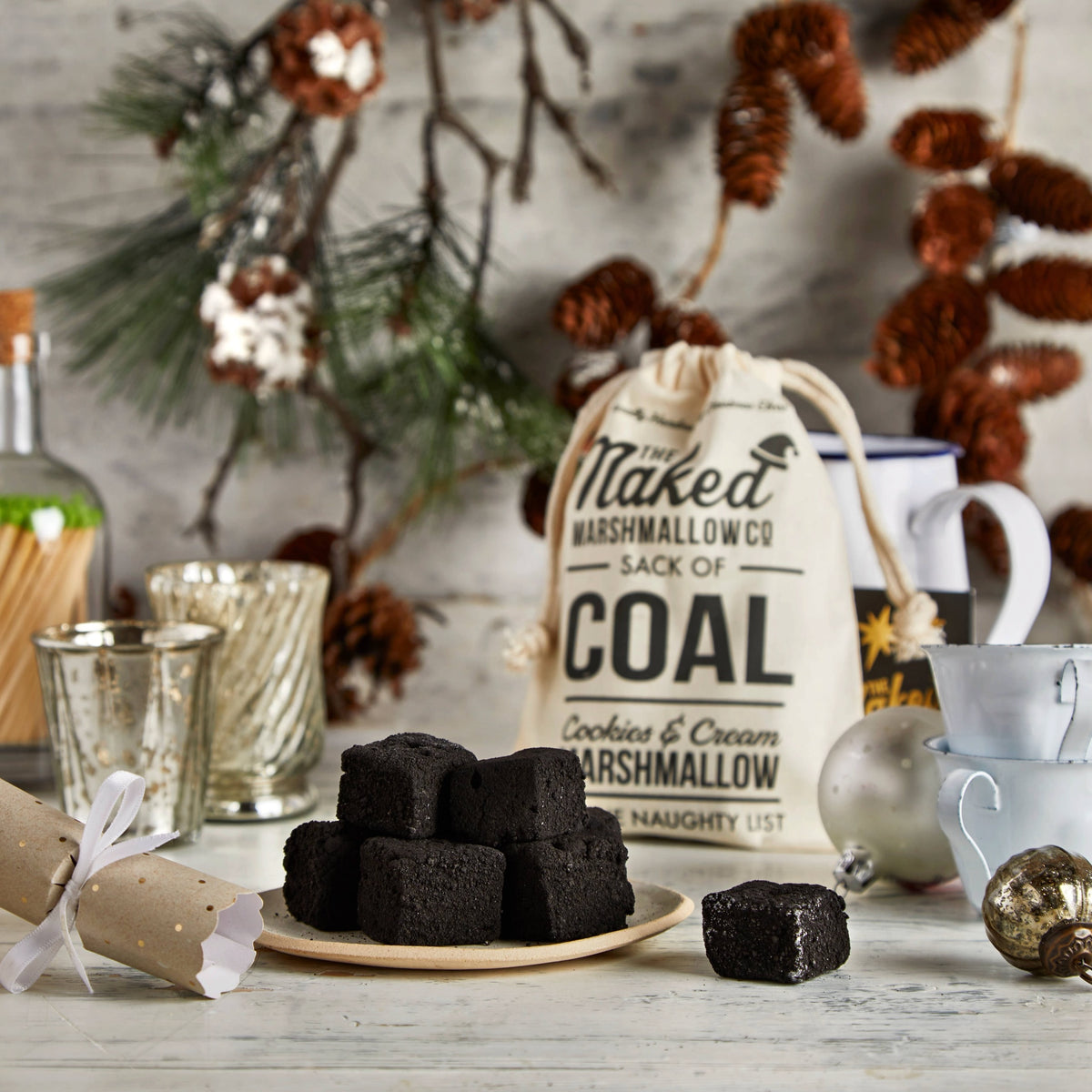 The Naked Marshmallow Co. gourmet cookies and cream coal marshmallows in a branded cotton sack for Christmas.